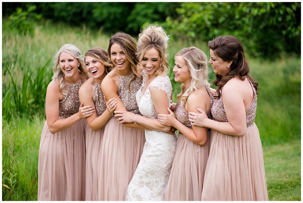 bride and bridesmaids laughing at jorgensen farms