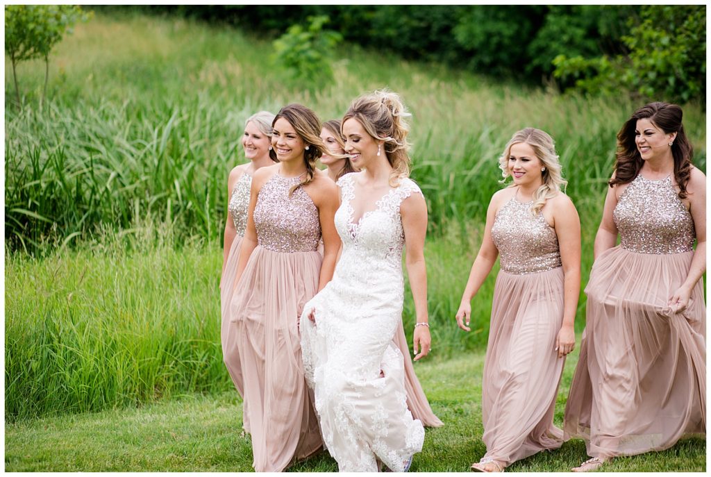 bride and bridesmaids walking at jorgensen farms