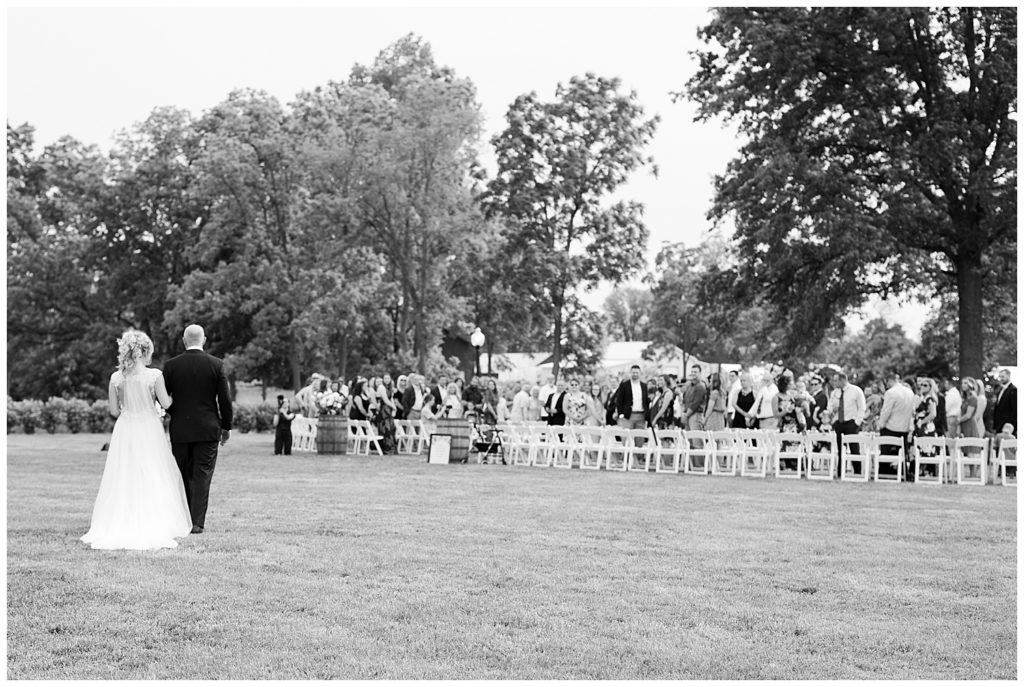 black and white image of dad walking bride down the aisle at jorgensen farms