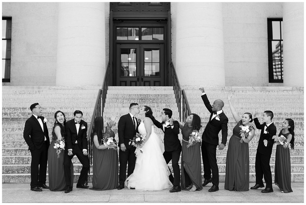 black and white image of bridal party cheering at ohio statehouse