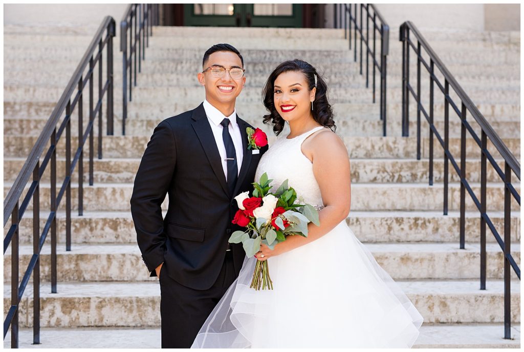 bride and groom smiling at camera at ohio statehouse