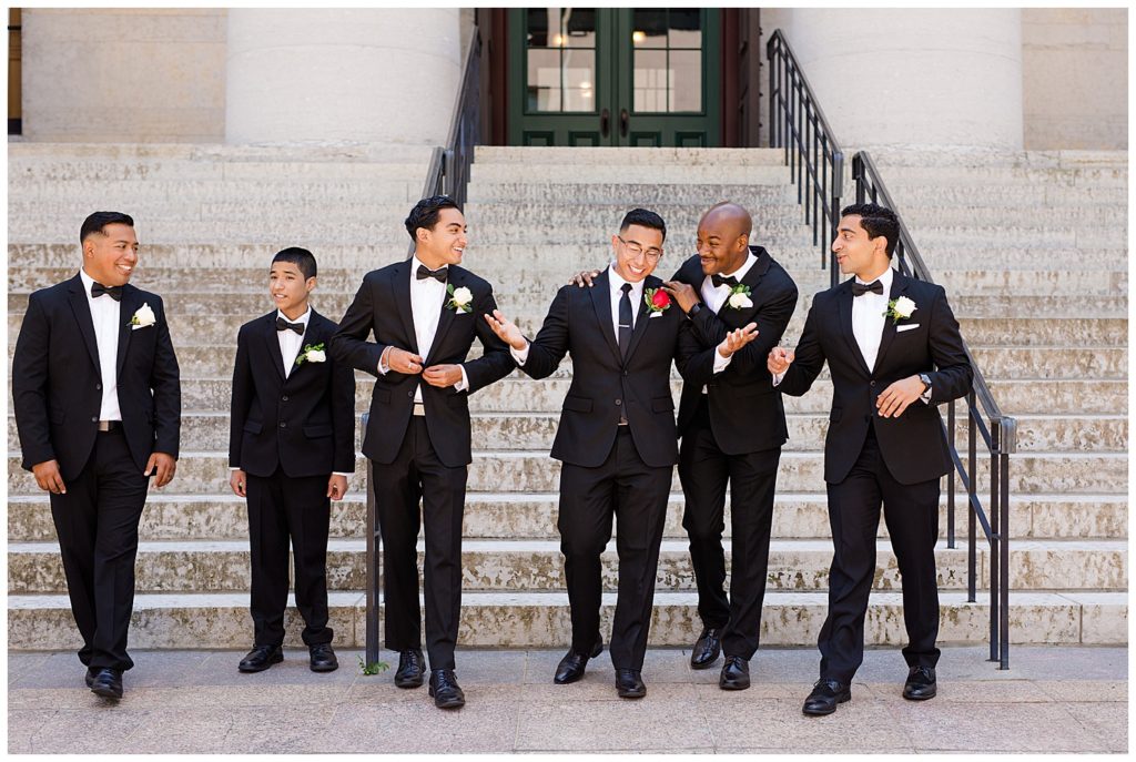 groom and groomsmen walking in front of steps at ohio statehouse