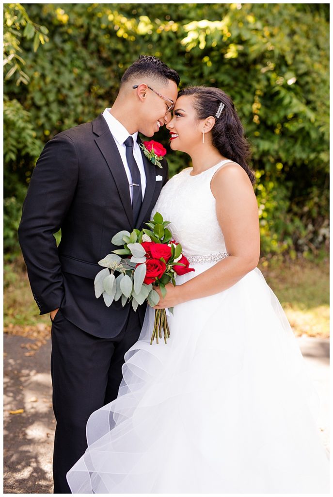 bride and groom smiling while touching foreheads