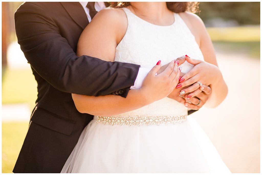 close up of bride and groom holding hands at stewart hall in obetz