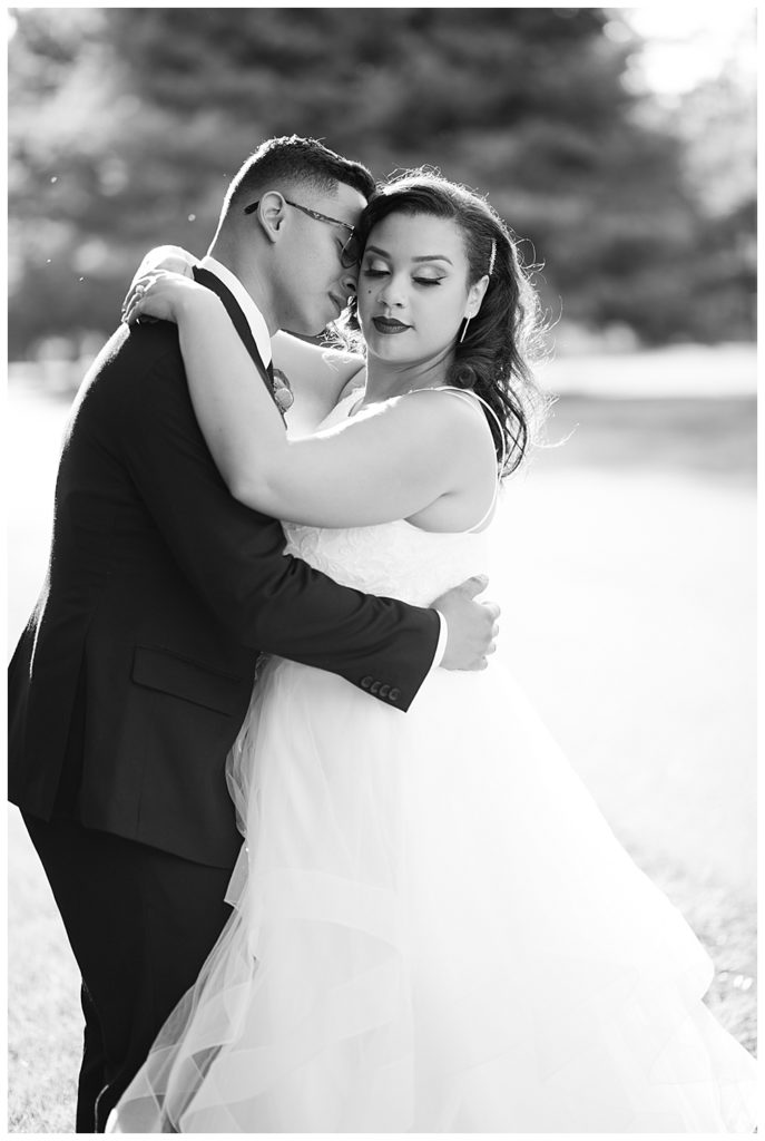 black and white image of bride and groom nuzzling during golden hour at stewart hall in obetz