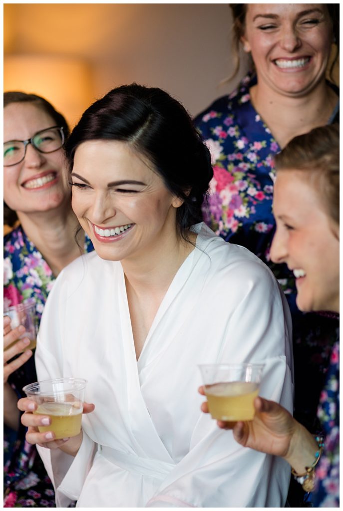 bride and bridesmaids laughing in robes