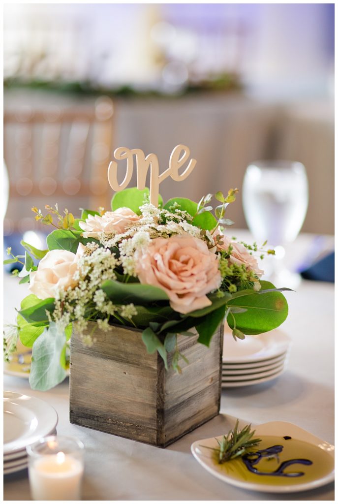 small wooden box centerpiece with pink roses, baby's breath, and greenery at watersedge in hilliard