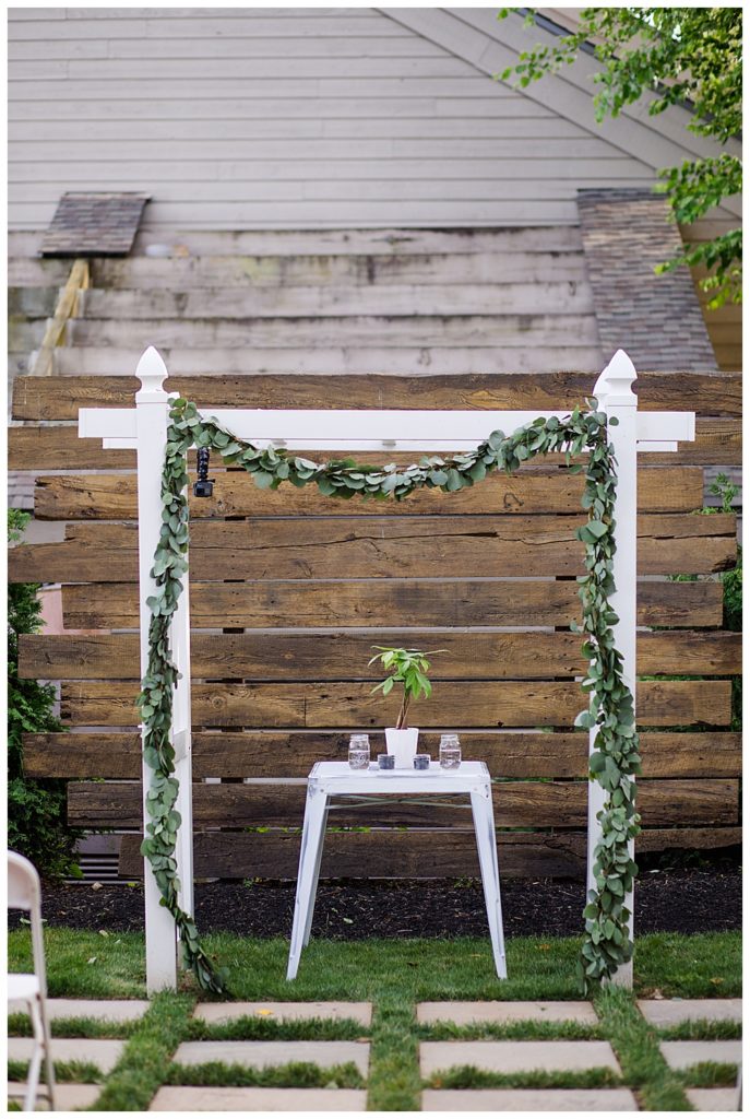 white trellis with eucalyptus garland for outdoor ceremony at watersedge in hilliard