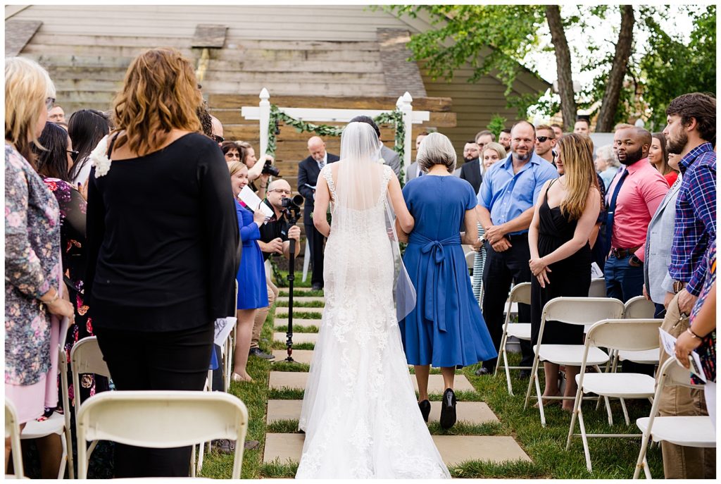 mother walking daughter down the aisle at watersedge in hilliard