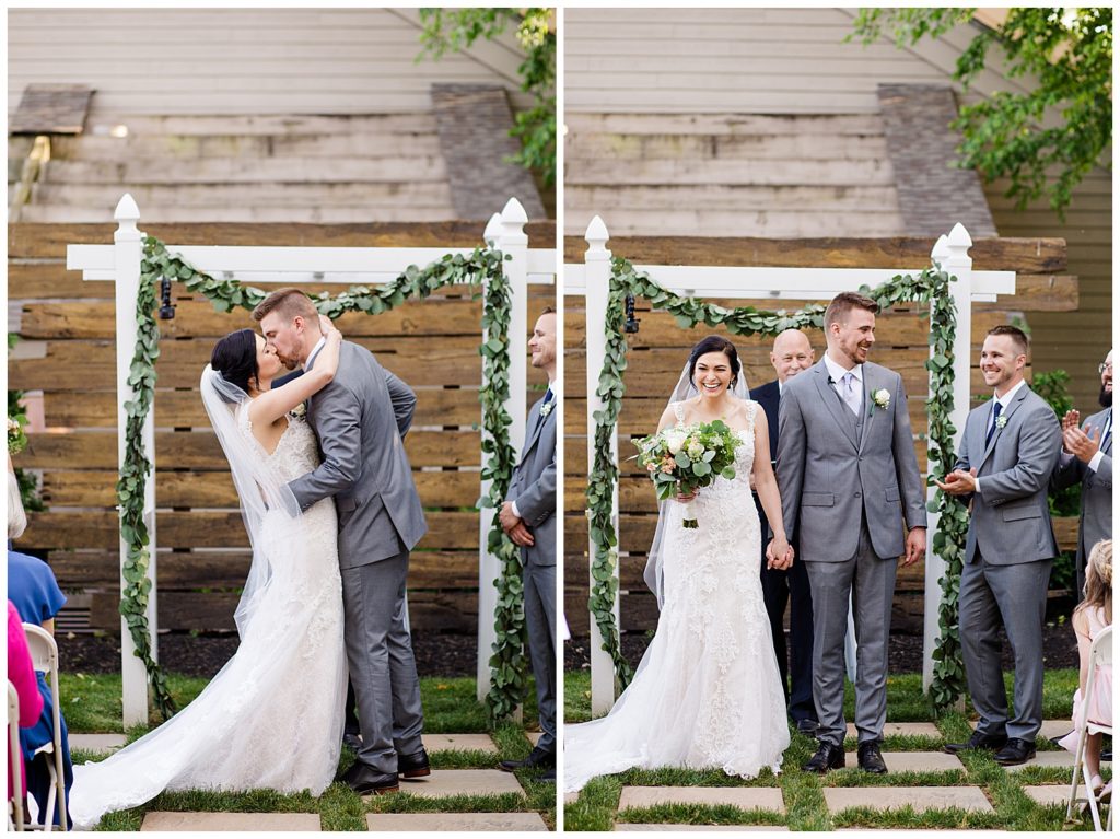 bride and groom share first kiss at watersedge in hilliard