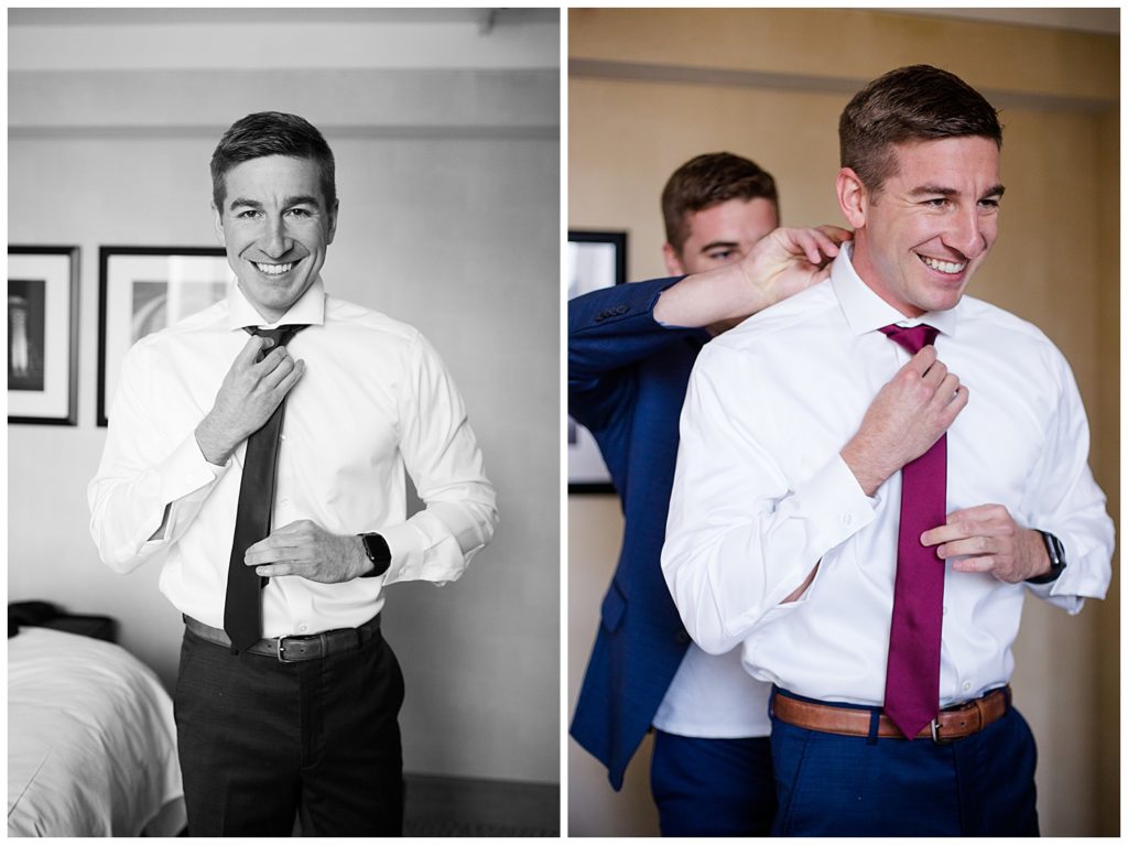 A photograph of a smiling groom adjusting his tie with help from his best man as he gets dressed for his wedding by Columbus OH wedding photographer, Alayna Parker Photography