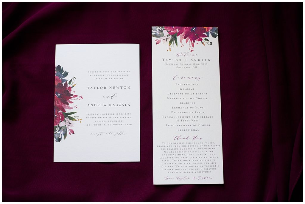 A photograph of a closeup of a wedding invitation and a program for the wedding ceremony by Columbus OH wedding photographer, Alayna Parker Photography