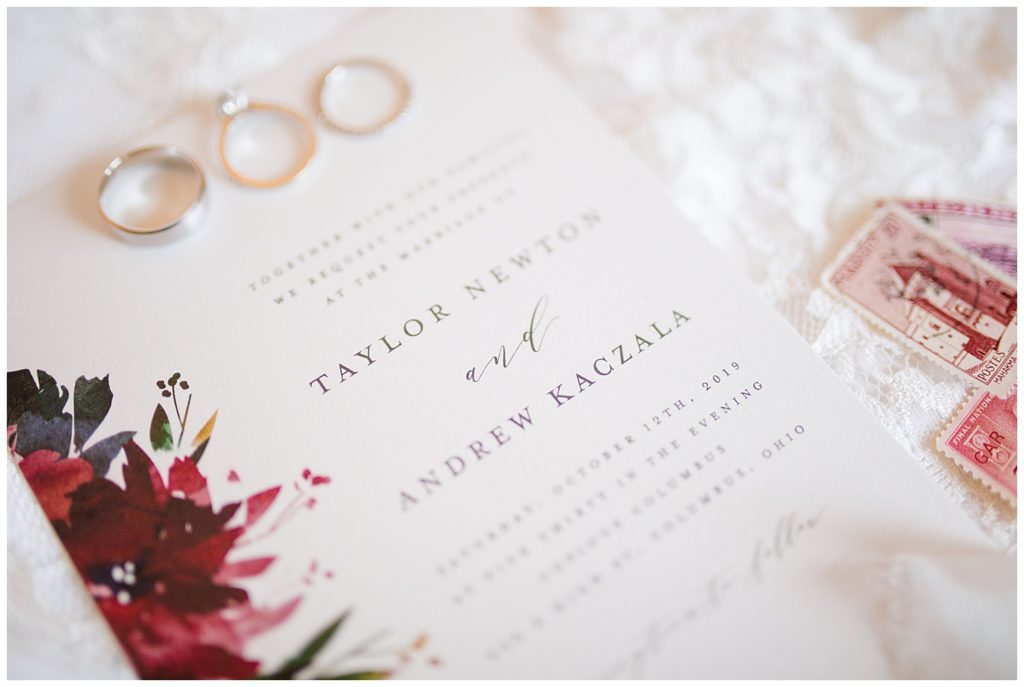 A photograph of a closeup of the beautiful wedding invitation and wedding rings by Columbus OH wedding photographer, Alayna Parker Photography