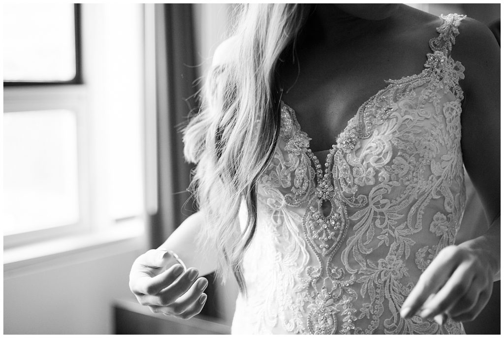 A photograph of a closeup black and white view of a bride in her dress, showing her hair and details of the dress by Columbus OH wedding photographer, Alayna Parker Photography