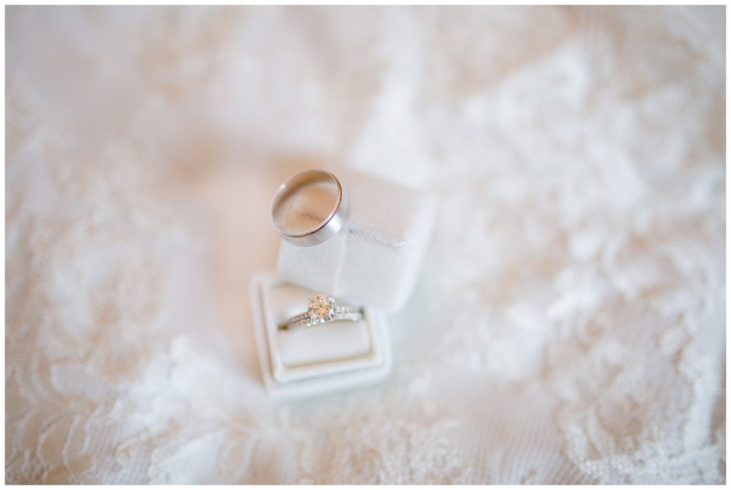 An image of a closeup display of the bride and groom's wedding rings by Columbus Ohio wedding photographer, Alayna Parker Photography