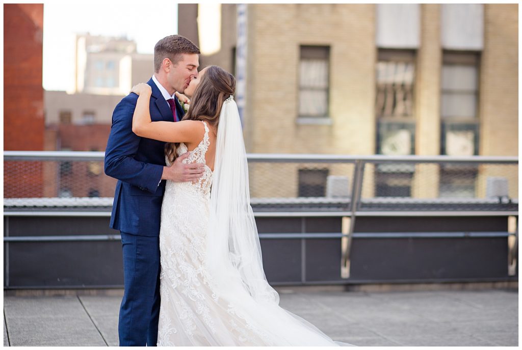 close up of bride and groom kissing after first look on rooftop at renaissance hotel
