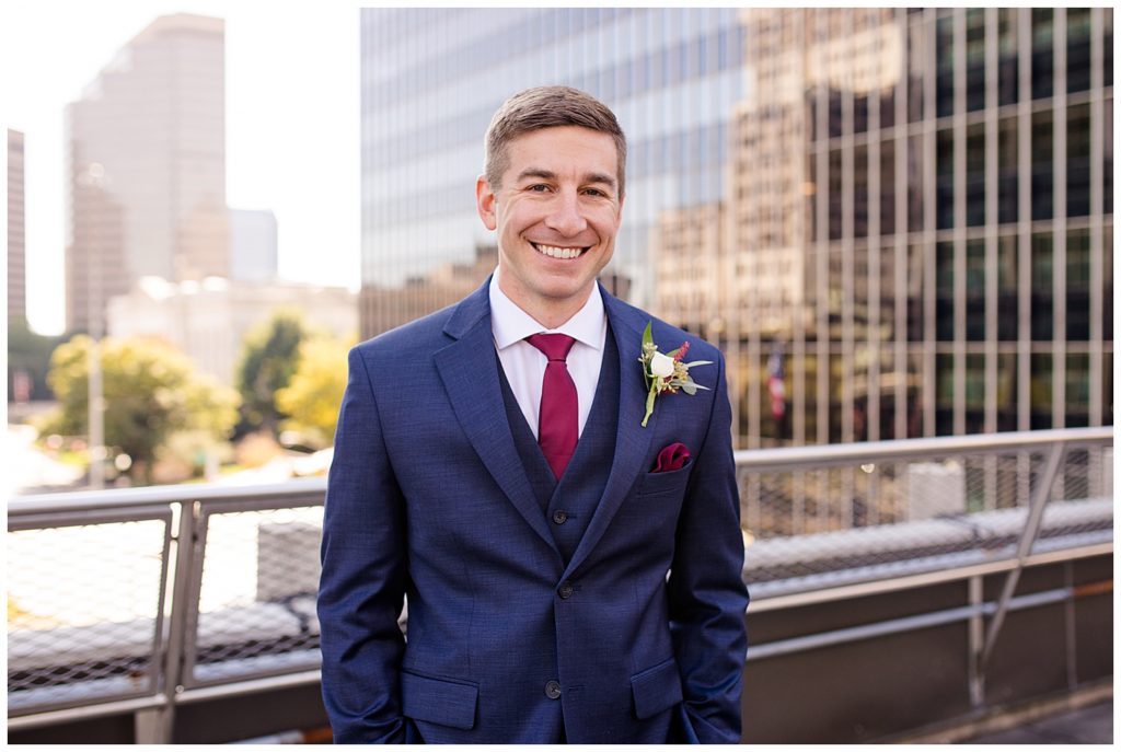 groom smiling at camera on rooftop at renaissance hotel