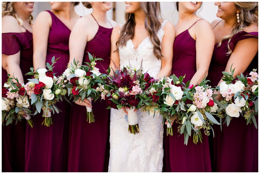 close up of bride and bridesmaids holding bouquets outside ohio statehouse