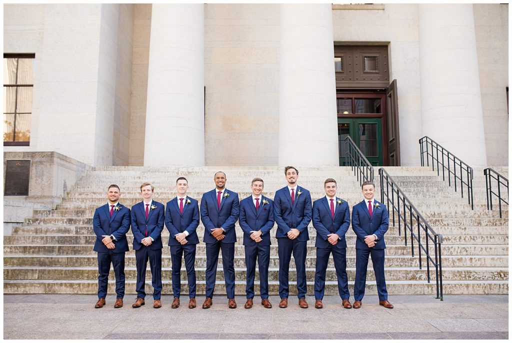 groom and groomsmen standing outside ohio statehouse