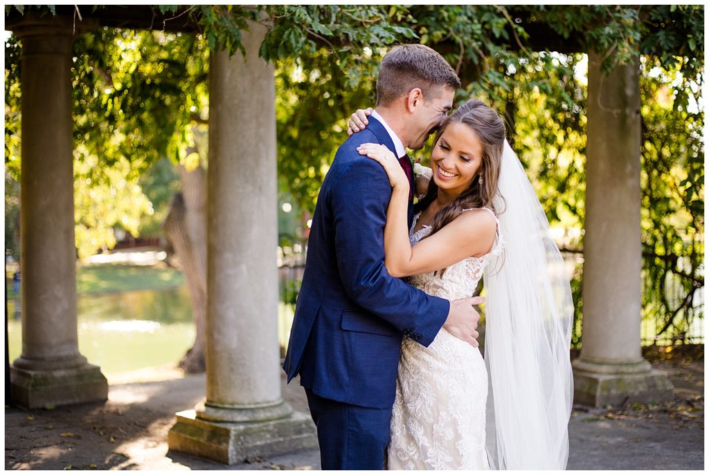 groom nuzzling into bride at schiller park in german village