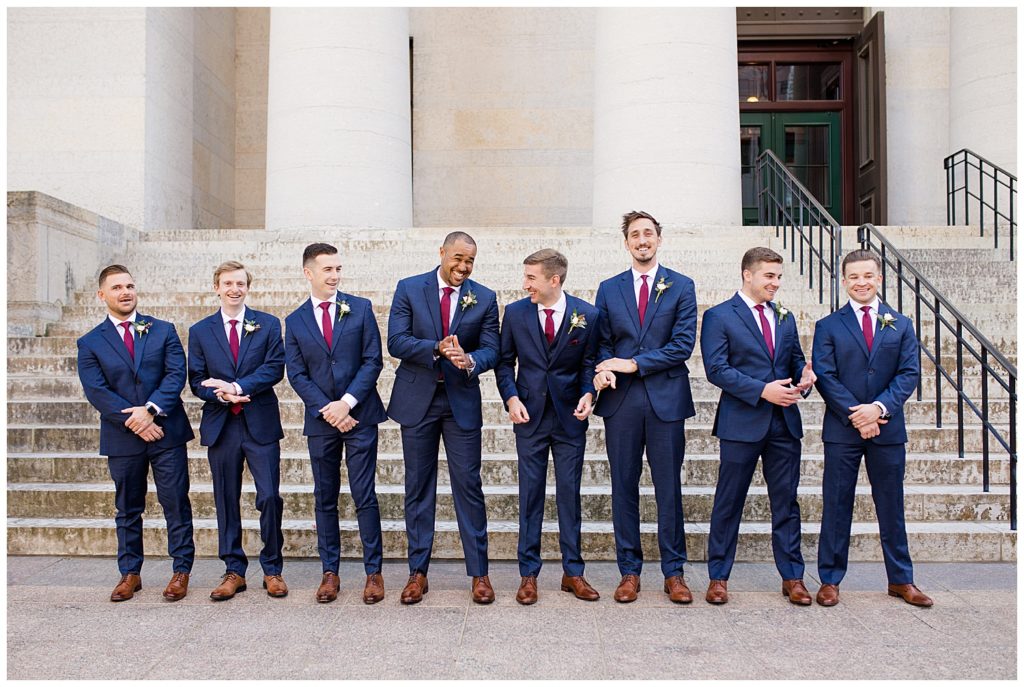 groom and groomsmen laughing outside ohio statehouse