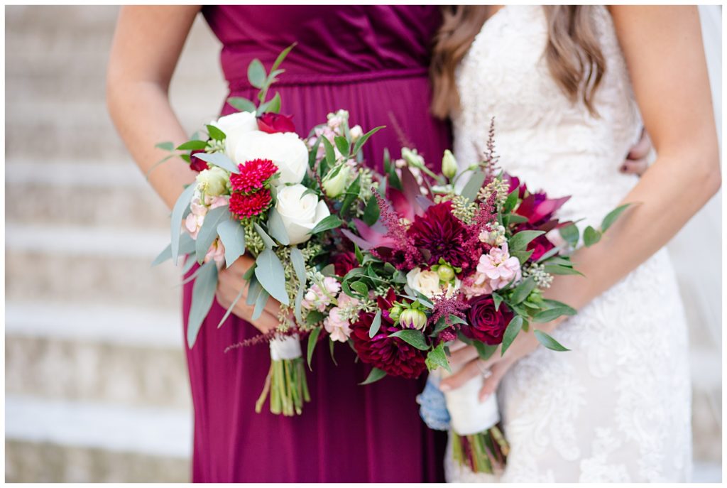 close up of bride and a bridesmaid holding flowers