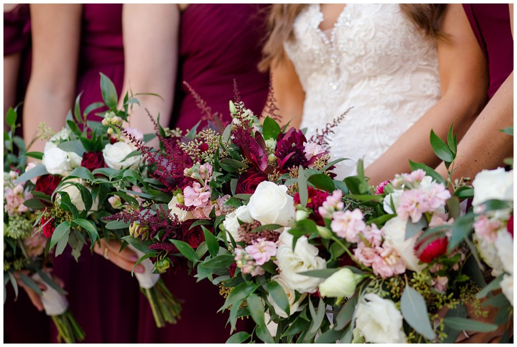 close up of bride and bridesmaids holding bouquets
