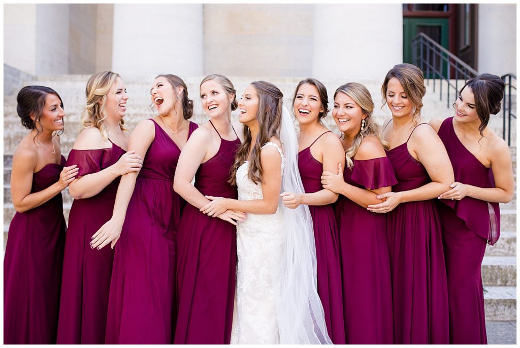 bride and bridesmaids laughing outside ohio statehouse
