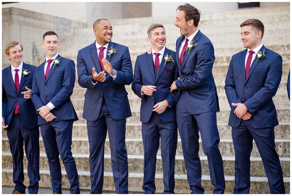groom and groomsmen laughing and joking around at ohio statehouse