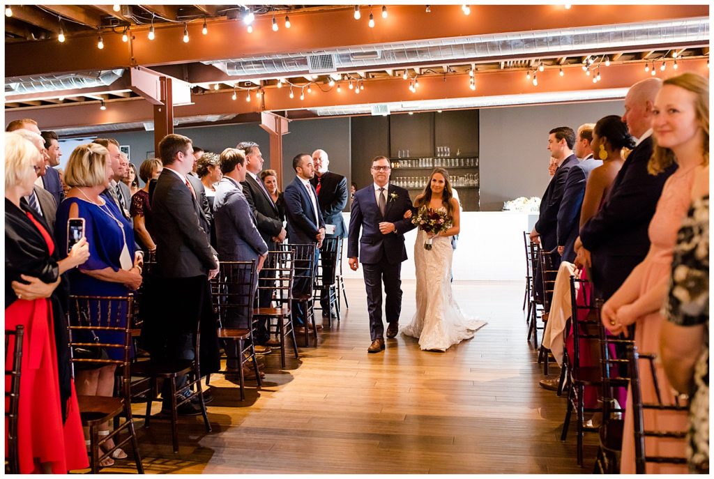 bride walking down aisle at copius