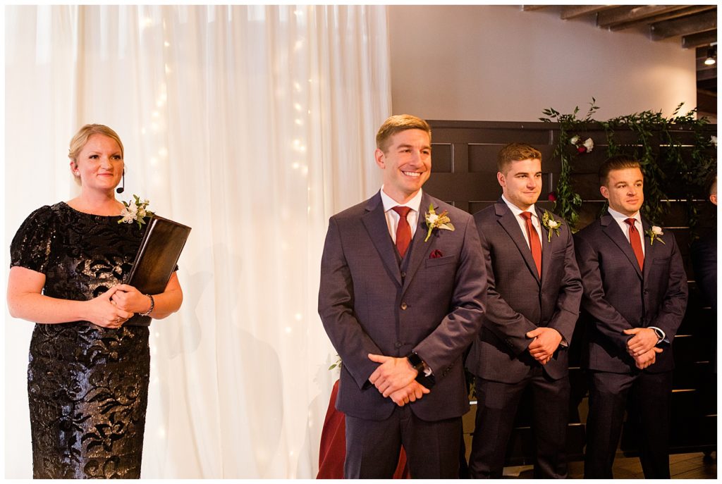 groom sees bride walking down the aisle at copius
