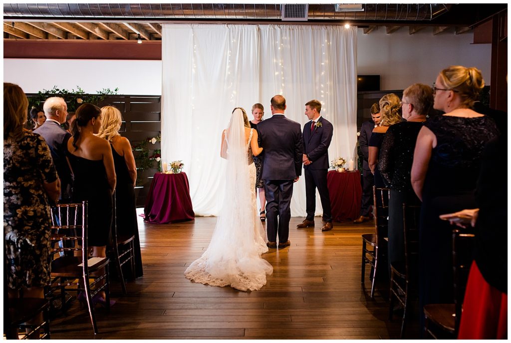 bride and father standing at altar at copius