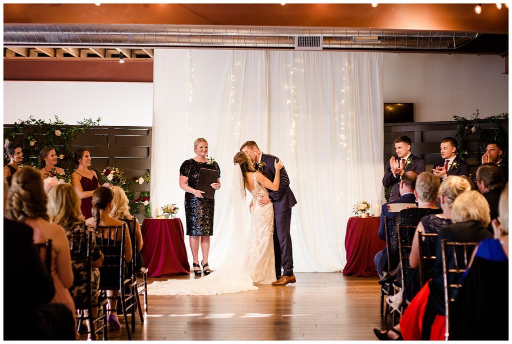 bride and groom share first kiss after being pronounced husband and wife at copius