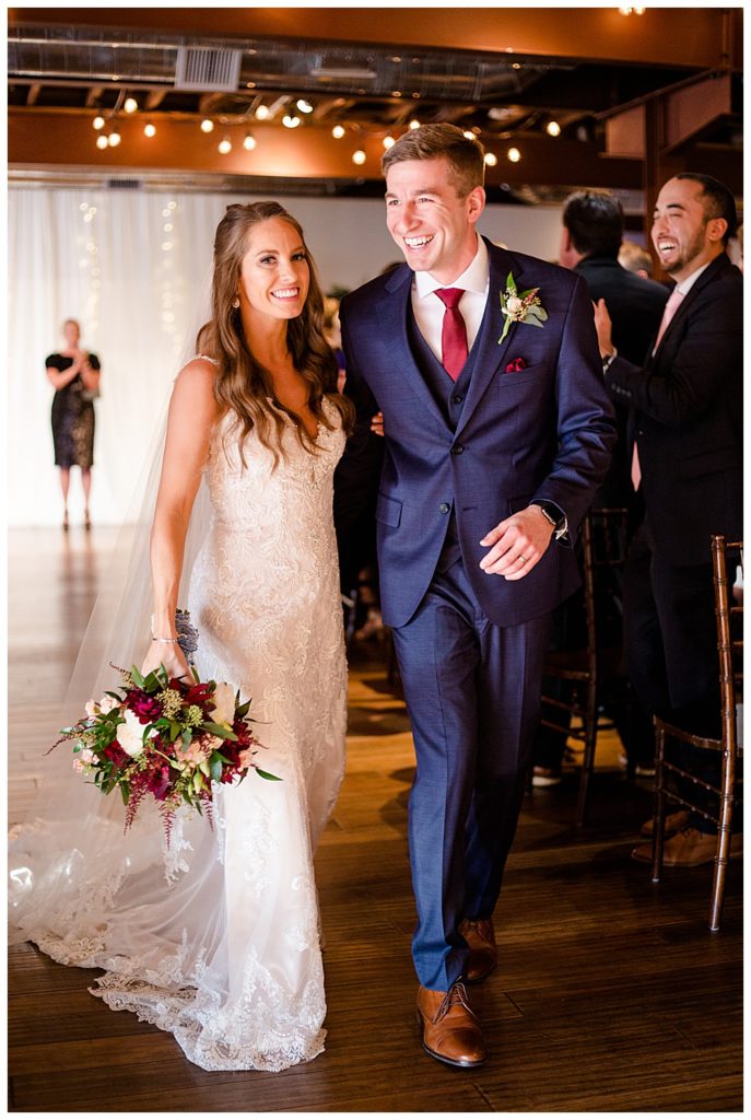 bride and groom walking back up aisle at copius