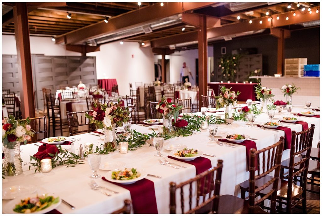 long head table with greenery garland at copius