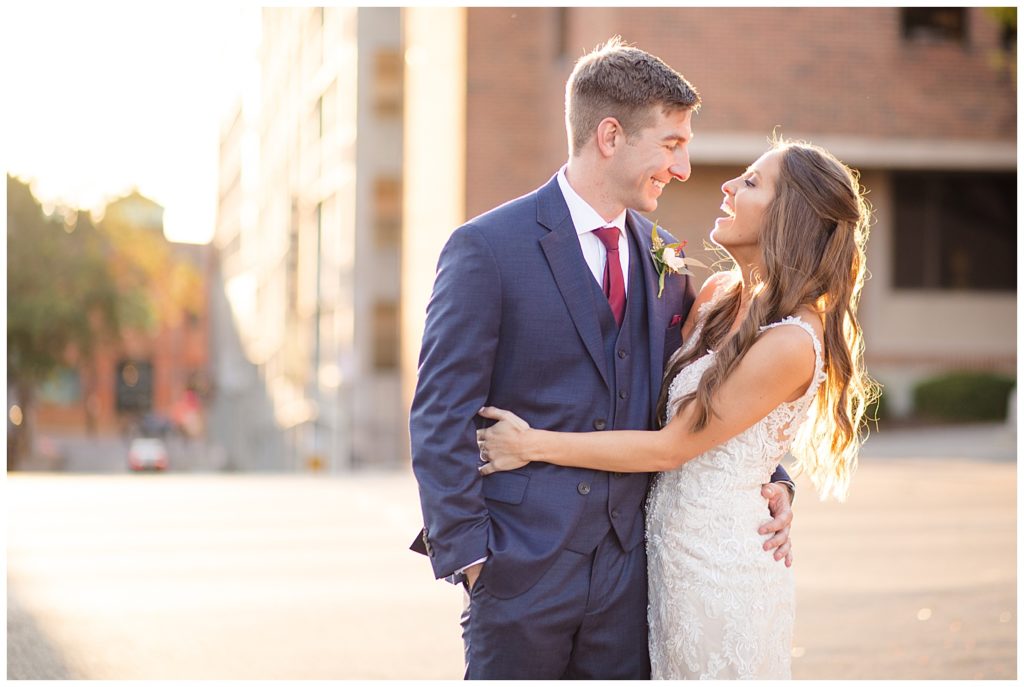 bride laughing at groom during golden hour in downtown columbus