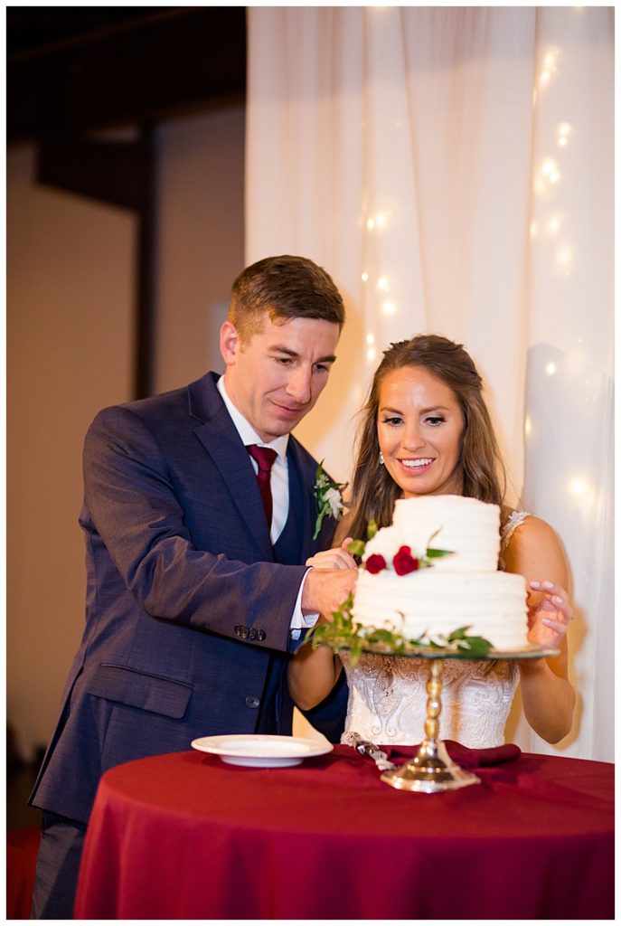 bride and groom cutting cake at copius