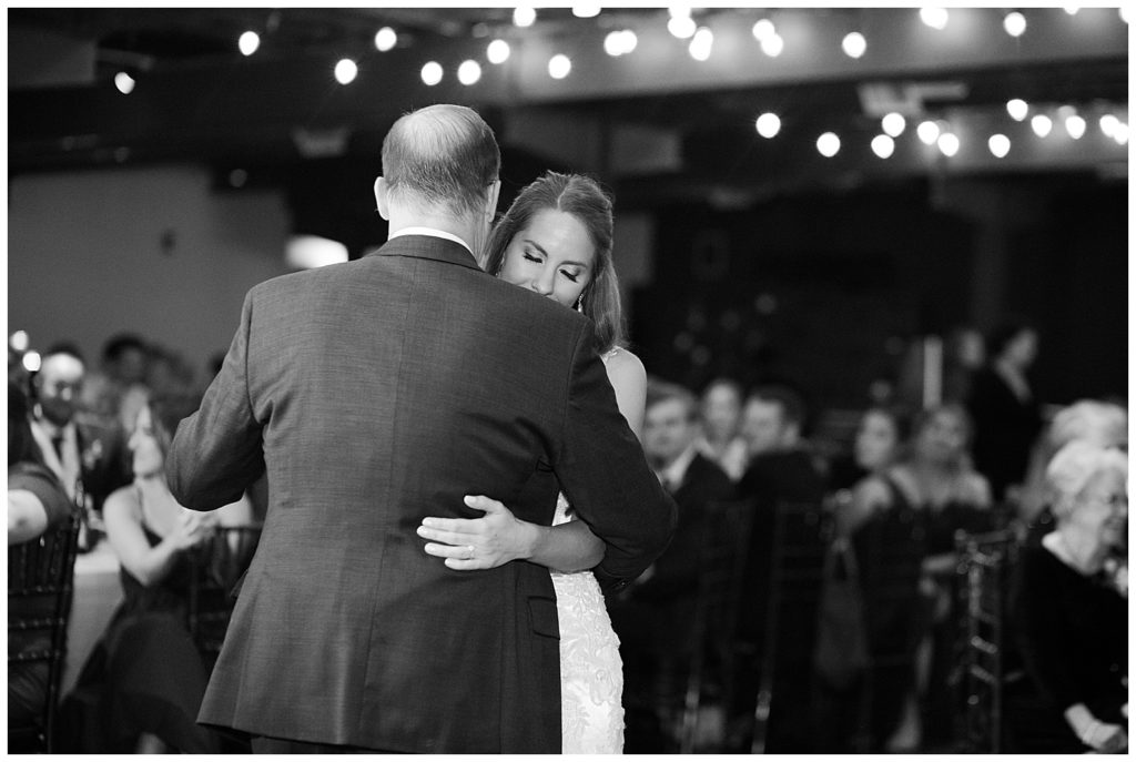 black and white image of bride and father dancing at copius