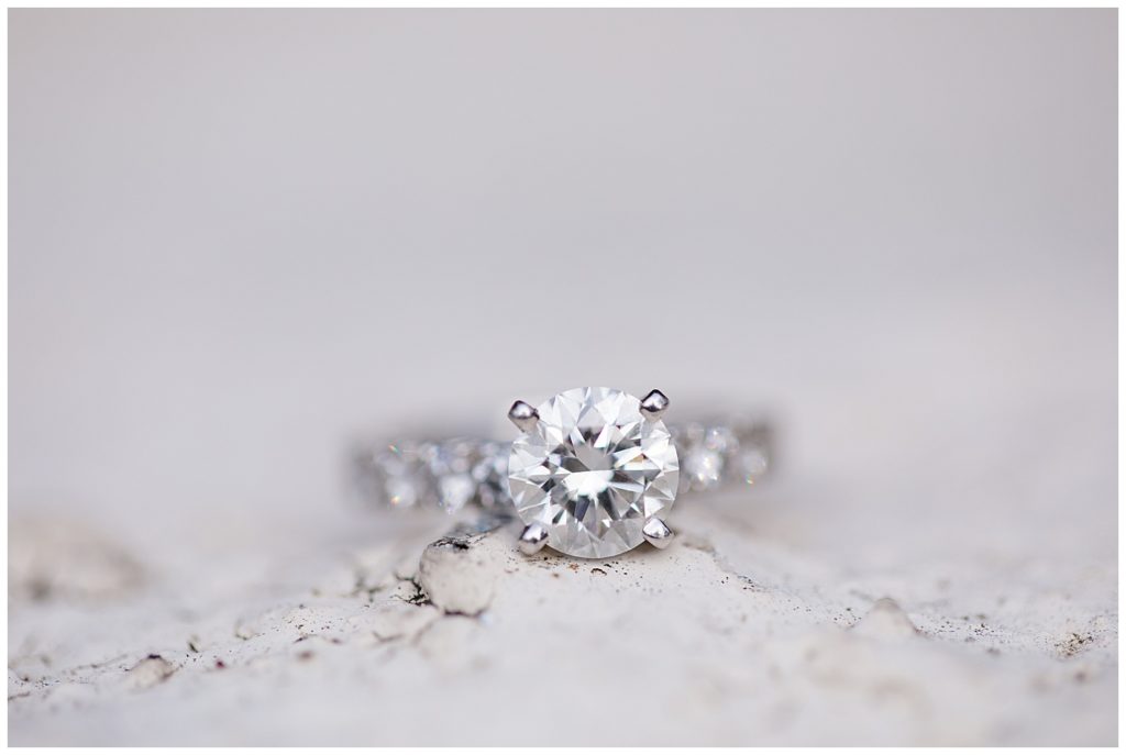 An image of a closeup of a diamond engagement ring sparkling brightly at Brookside Golf & Country Club by Columbus Ohio engagement photographer, Alayna Parker Photography