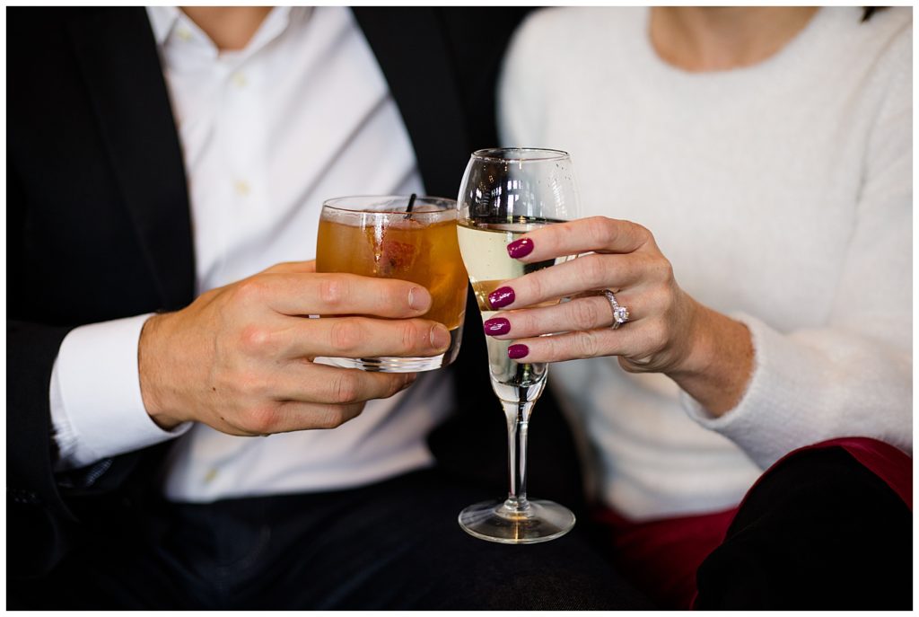 A picture of a closeup view of the engaged couple's hands holding their cocktail drinks, showing off the engagement ring at Brookside Golf & Country Club by Columbus engagement photographer, Alayna Parker Photography
