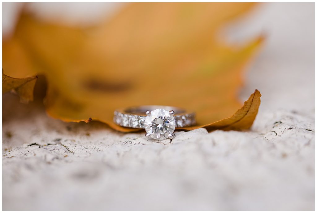 A photograph of a closeup view of an engagement ring displayed on a beautiful fall leaf at Brookside Golf & Country Club by Columbus OH engagement photographer, Alayna Parker Photography