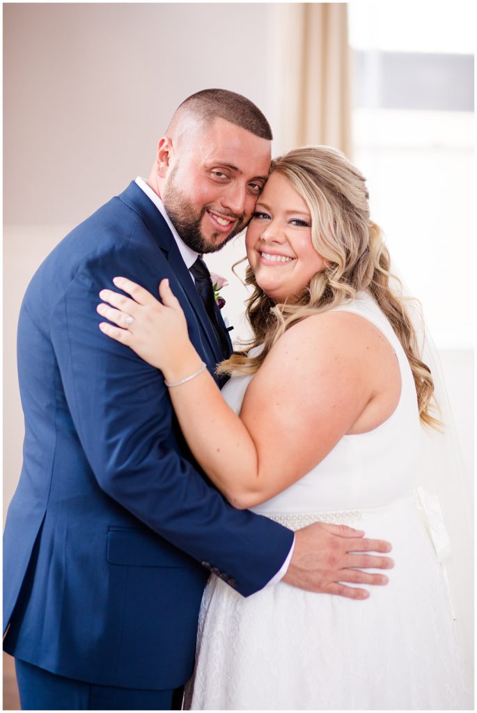 bride and groom smiling at camera at the postmark