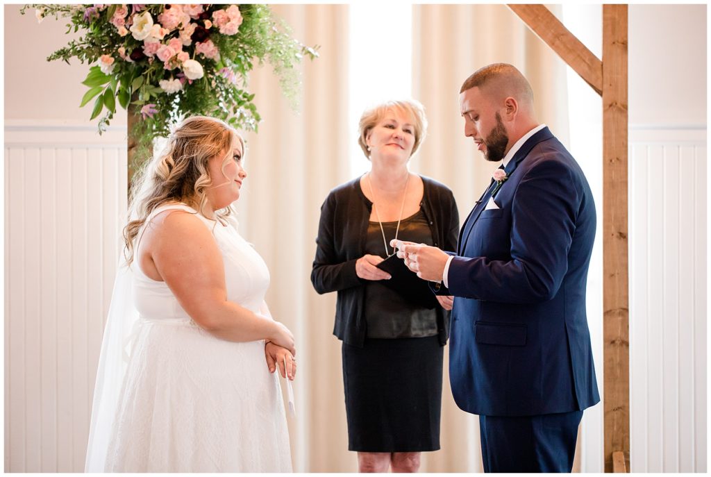 groom reading vows at the postmark
