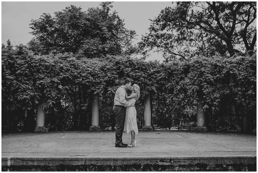 black and white image of couple kissing on stage at schiller park