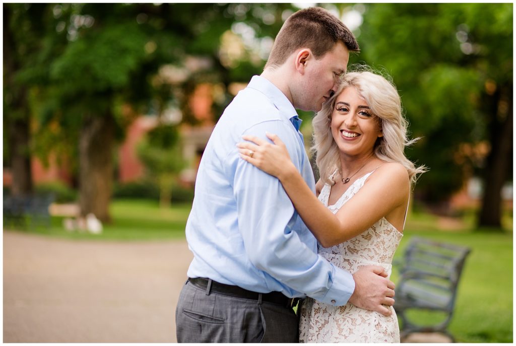 woman looking at camera and smiling with her fiance at schiller park